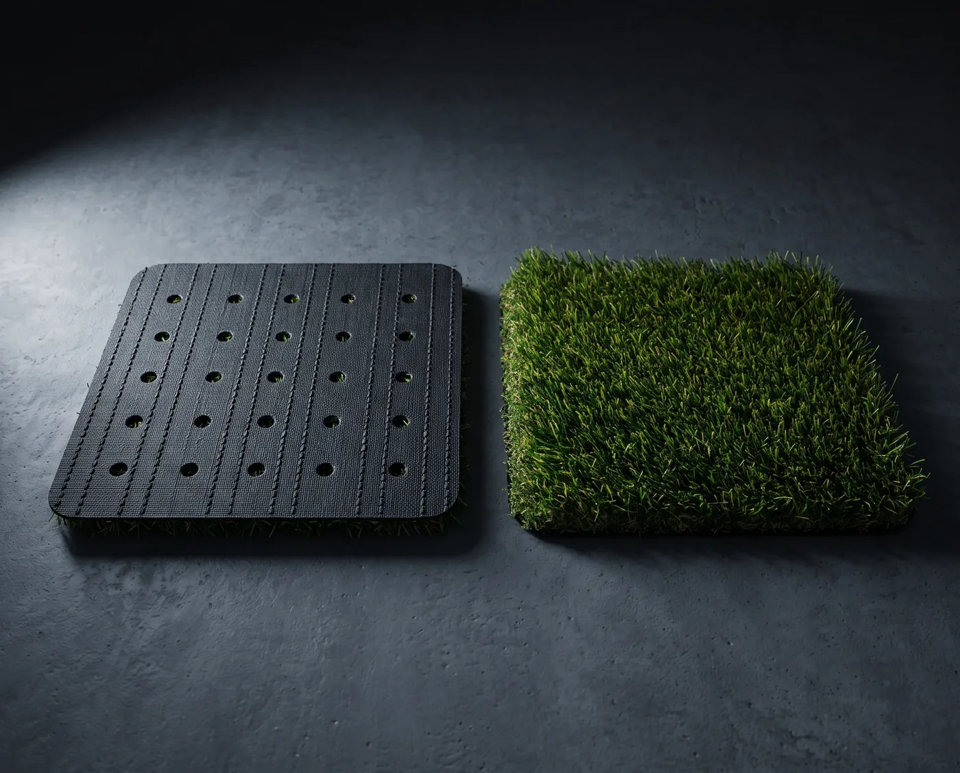 A turf swatch face down showing its stitched backing and drainage holes
